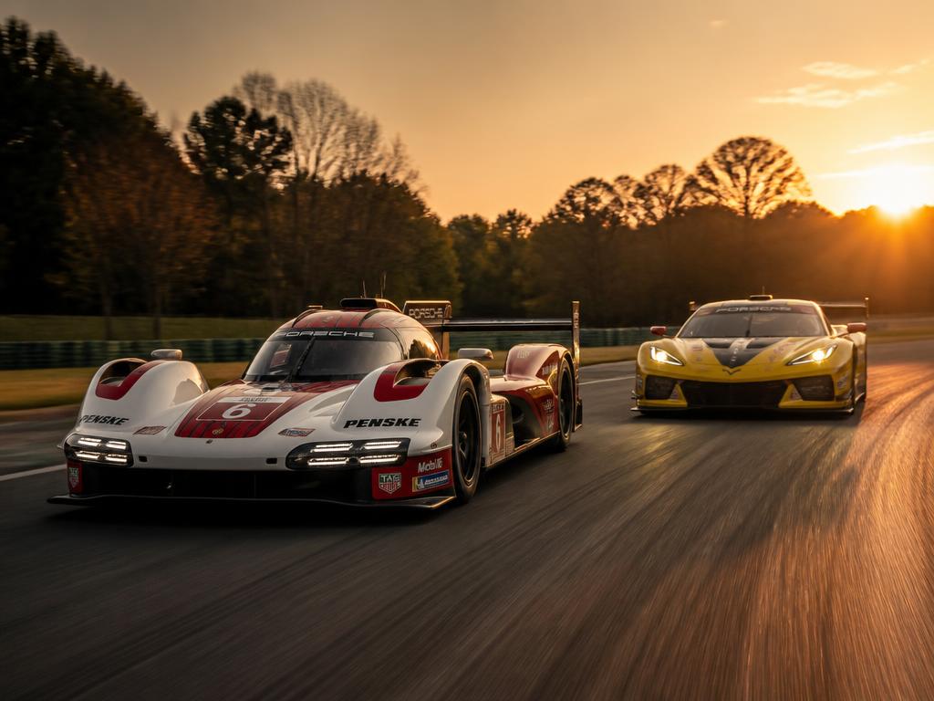 IMSA GTP prototype and GT car racing at dusk